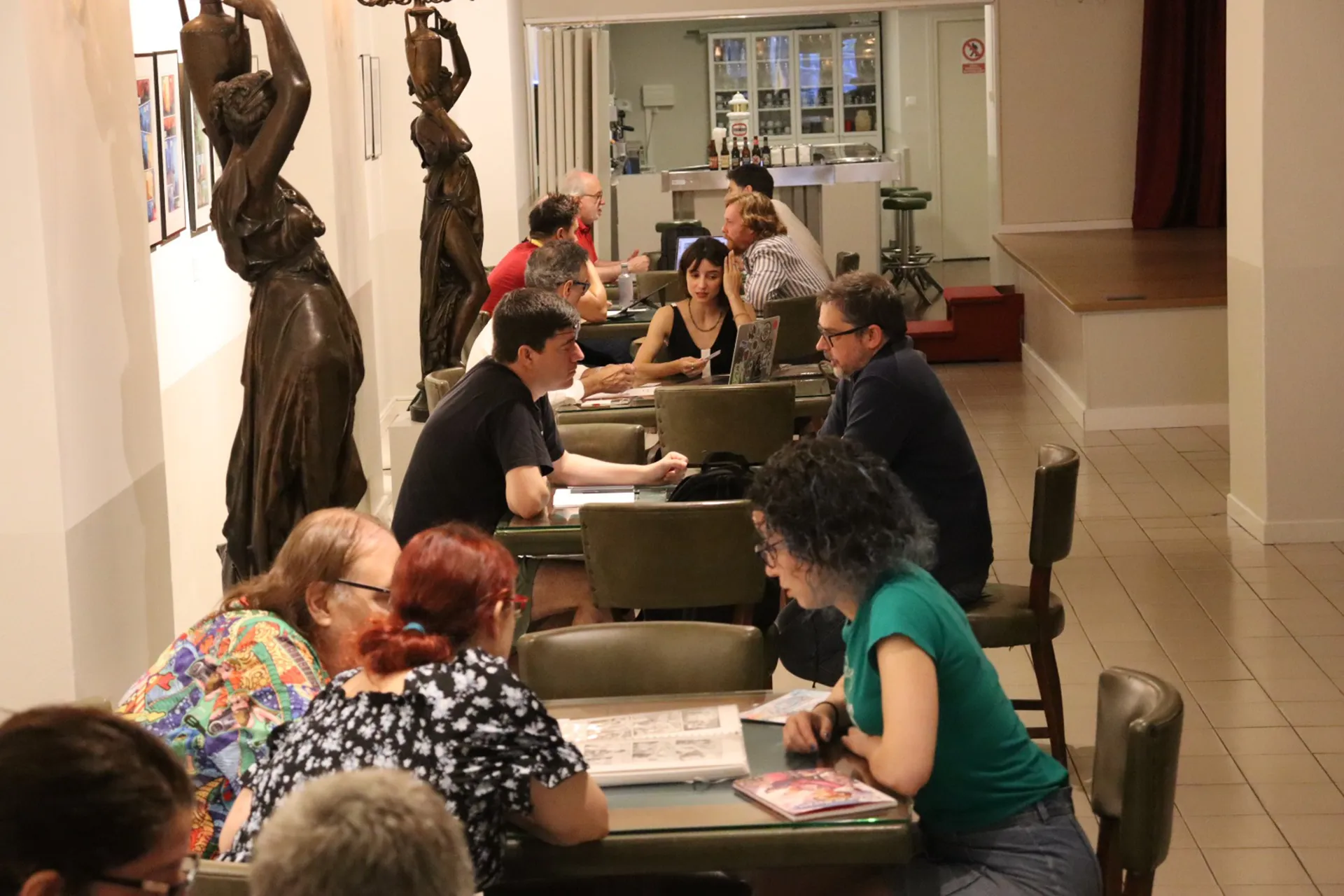 Profesionais da ilustración revisando os seus portfolios en mesas
