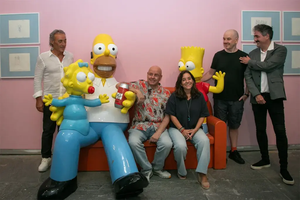 Personalidades sentadas no sofá dos Simpsons.